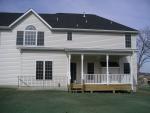 Back of house with walk-up from basement and back porch, window in upper left is master bedroom, small window is laundry room, f