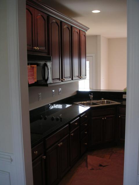 Looking into kitchen from dining room, LOVE the cabinets, granite counters, built-in flat cooktop and built-in microwave