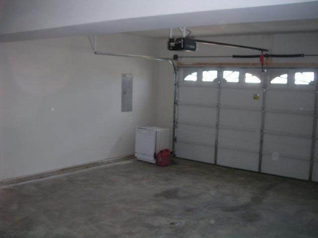 Garage, LOTS of storage space just to left of pictures, garage door opener already there, not sure whose dishwasher that is