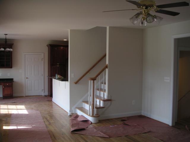 Looking through family room past back half of stairs into morning room and ktichen, good shot of bar where we'll have stools