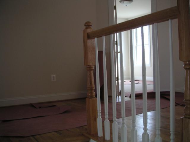 Looking up the middle landing of the stairs to second floor landing