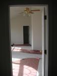 Looking from foyer through master bedroom into sitting room and my walk-in closet, love the vaulted ceiling and fan (back right)