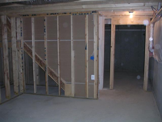 Looking from future media room through basement landing to the long basement room